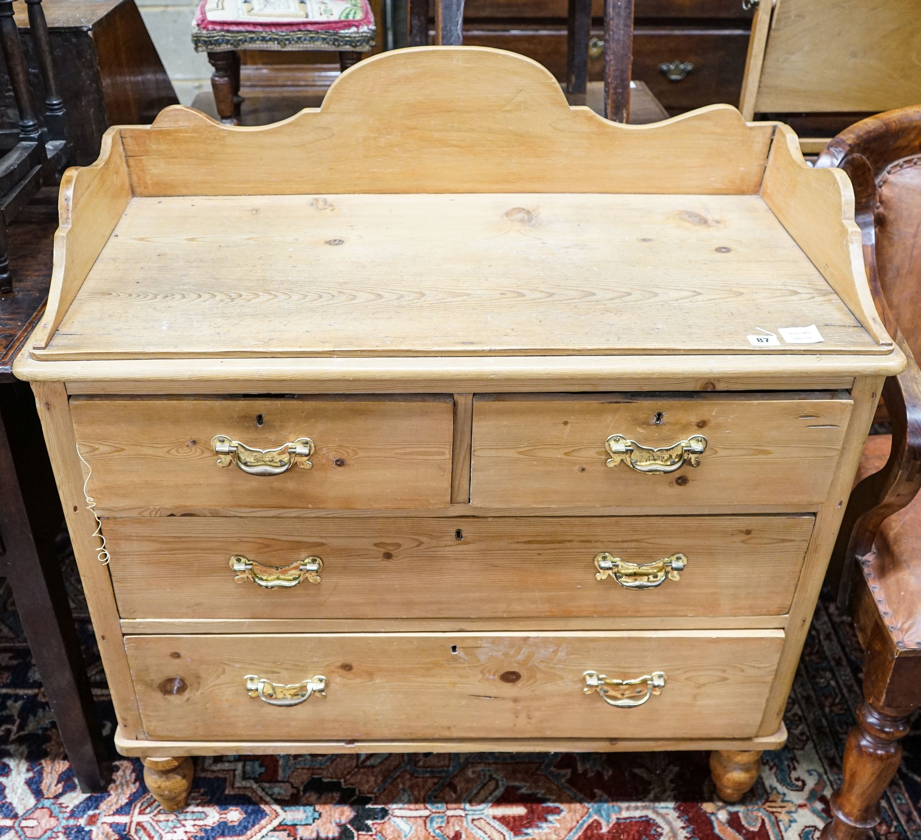 A Victorian pine chest, with three quarter gallery, four drawers and turned feet, width 96cm, depth 44cm, height 99cm